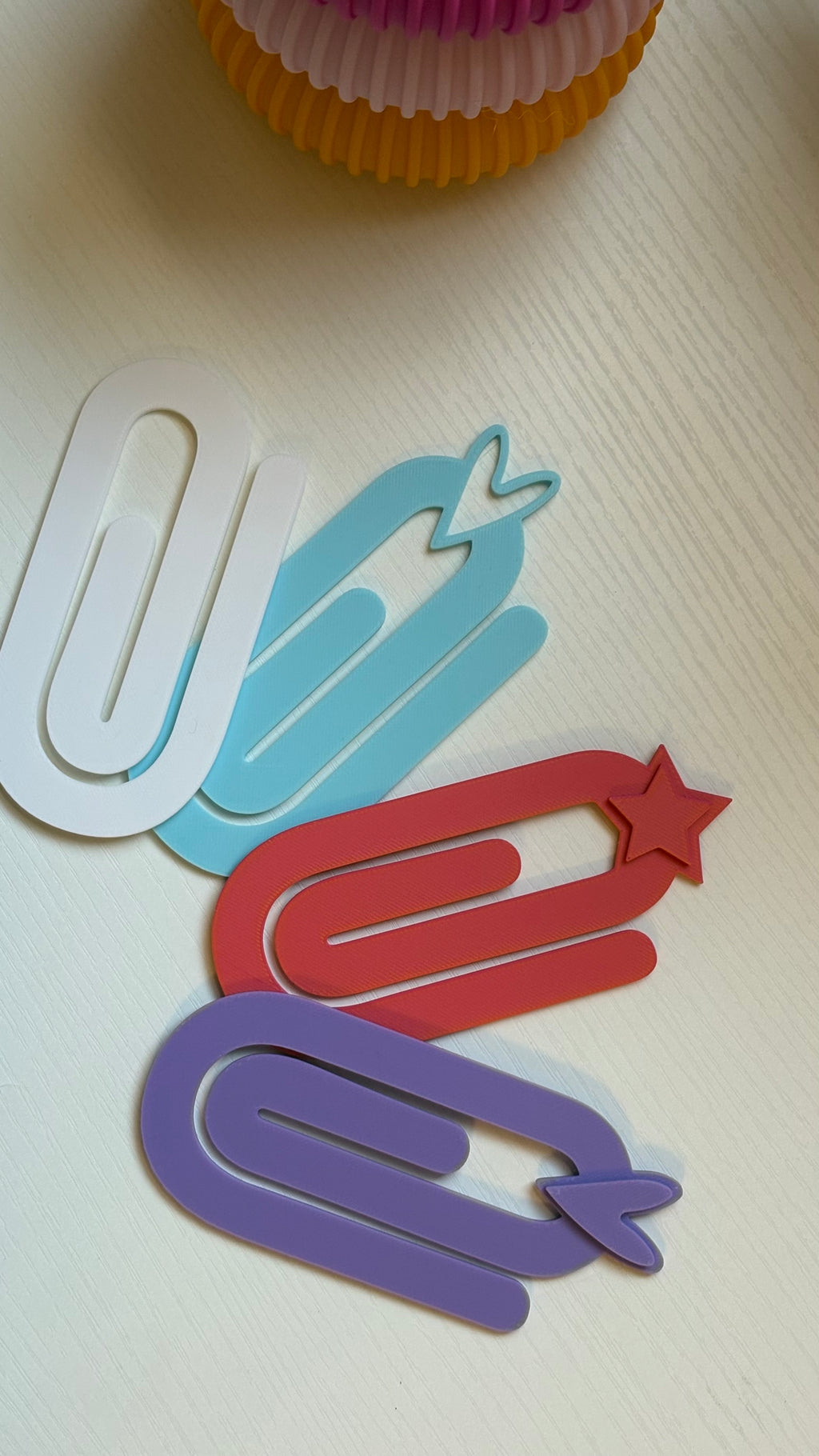 Colorful paper clips on a white surface