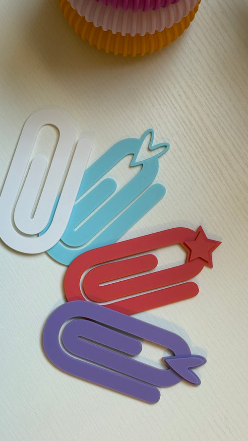 Colorful paper clips on a white surface